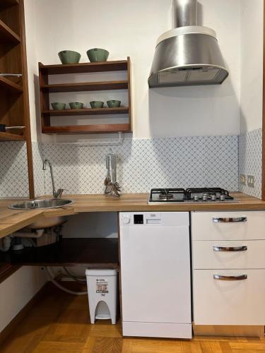a kitchen with a sink and a stove top oven at Suite D'Annunzio in Ravenna