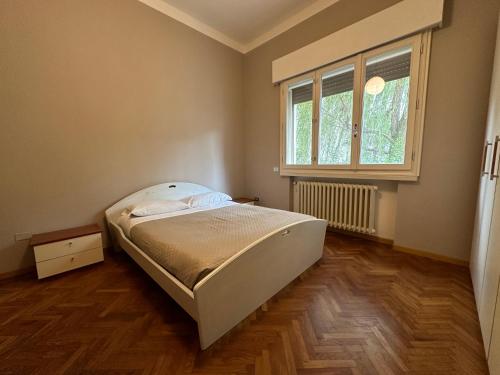 a small bedroom with a bed and a window at Suite D'Annunzio in Ravenna