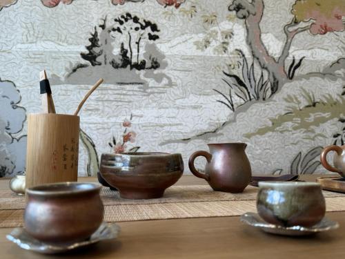 a table with bowls and cups on top of it at FORMOSA DIJON in Étaules
