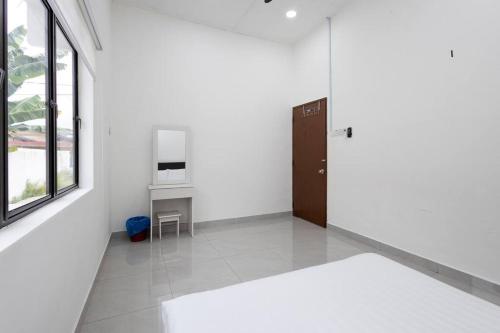 a white room with a door and a table at Dream - Autumn at Pinji Ipoh Town in Ipoh