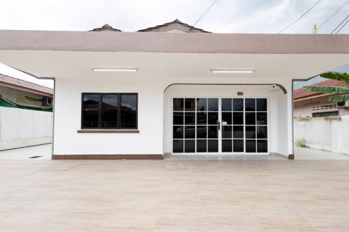 a white building with a large garage door at Dream - Autumn at Pinji Ipoh Town in Ipoh