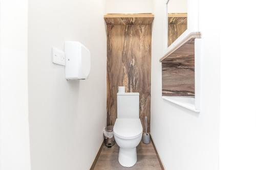 a bathroom with a white toilet in a room at The Redwell Country Inn in Arkholme