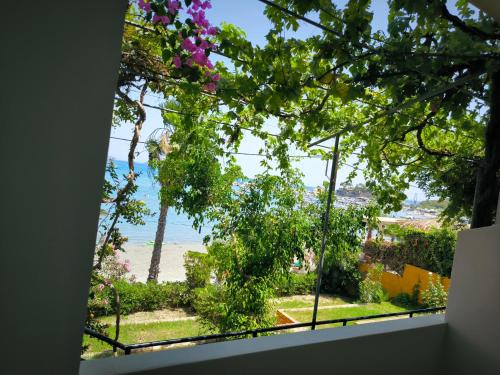 a window with a view of the beach at Aggelika Apartments in Lithakia