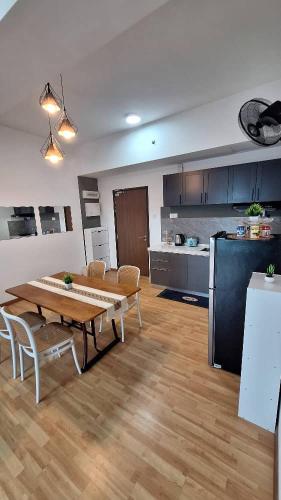 a living room with a table and a kitchen at Imperium Residence 1 Queen bed Sea View in Kuantan