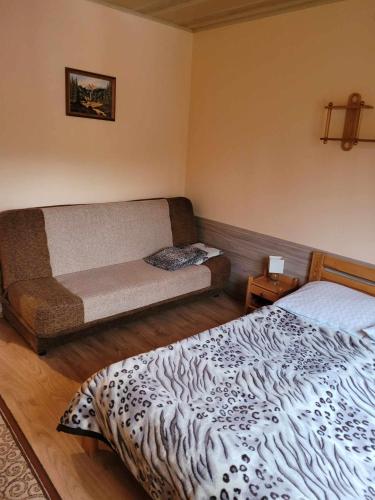 a room with two beds and a couch in it at Jelonek Zawoja in Zawoja