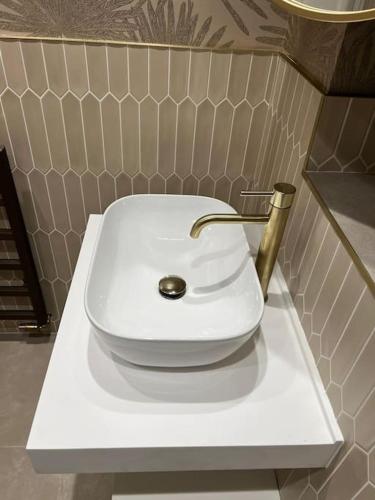 a white toilet sitting on a counter in a bathroom at Orme Villa, Hot Tub, Llandudno, Stunning Views , sleeps 12 in Llandudno