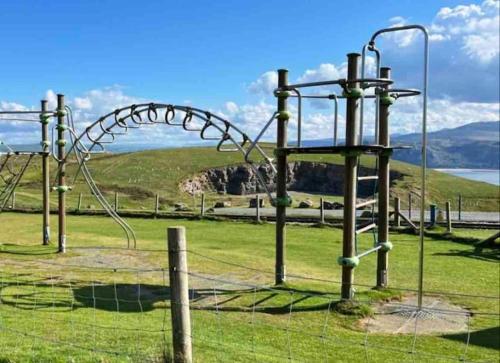 a roller coaster in a field with a fence at Orme Villa, Hot Tub, Llandudno, Stunning Views , sleeps 12 in Llandudno