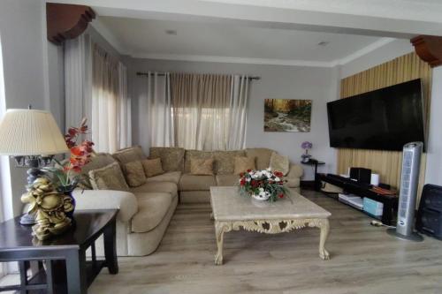 a living room with a couch and a table at Tampus Staycation Rental Cebu in Bulacao