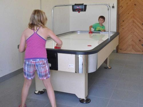 a woman standing in front of a ping pong table at Holiday home in Faak am See in Faak am See