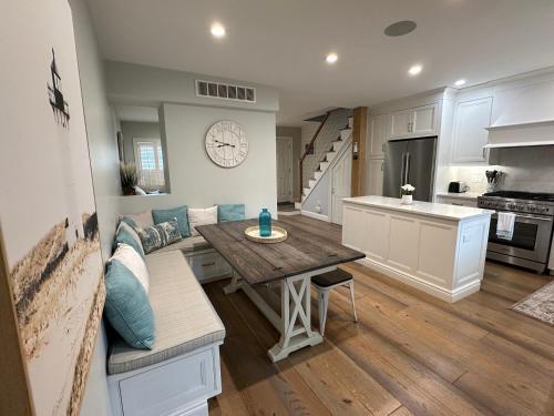 a kitchen and living room with a table and a couch at Beautifully Renovated 2 Bed 2 Bath Private Home in Newport