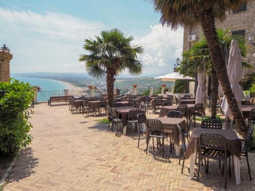 a restaurant with tables and chairs and a view of the ocean at Casa Sant’Anna in Vasto