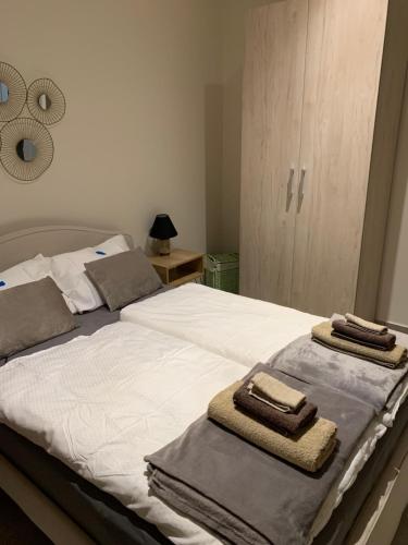 a bedroom with a bed with towels on it at Villanet SeaView Halkidiki in Mola Kalyva