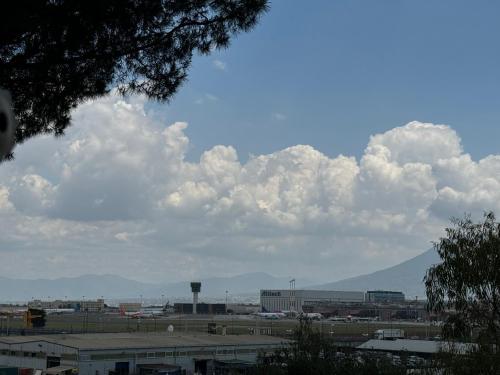 a view of an airport with clouds in the sky at Rosy home in Naples