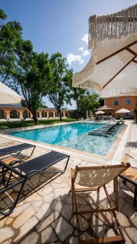 a swimming pool with two lounge chairs and a umbrella at Ema Houses in Antalya