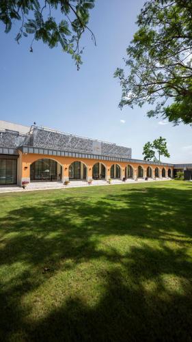 a large building with a grass field in front of it at Ema Houses in Antalya