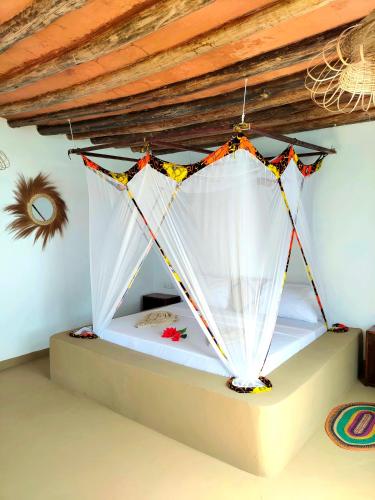 Postel nebo postele na pokoji v ubytování Eden Rock Zanzibar