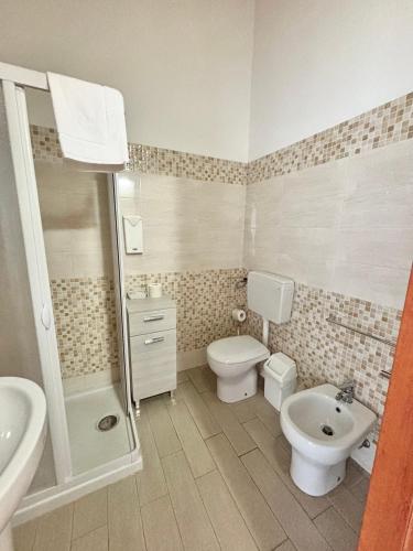 a bathroom with a sink and a toilet and a shower at Il Veliero in Marzamemi
