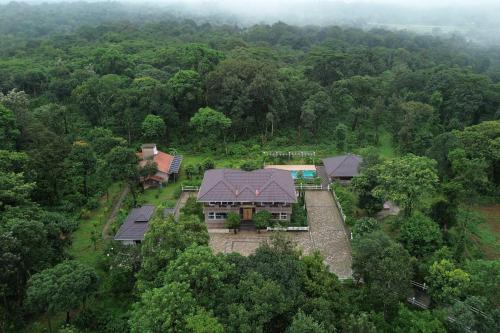 an aerial view of a house in the middle of a forest at 5BR Coffee & Mist Luxury Villa-High Speed Wifi- Comp Breakfast, Pvt Pool, and Coffee Estate Virajpet in Madikeri