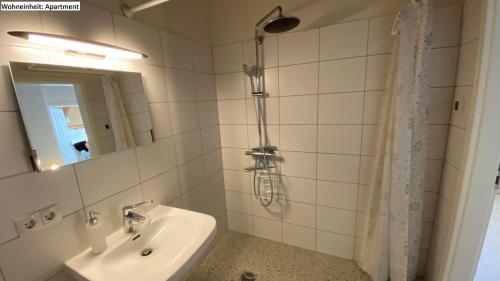 a bathroom with a sink and a shower at Blaue Perle Templin in Templin