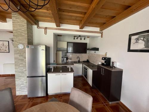 a kitchen with a stainless steel refrigerator and cabinets at Rigel in Varaždinske Toplice