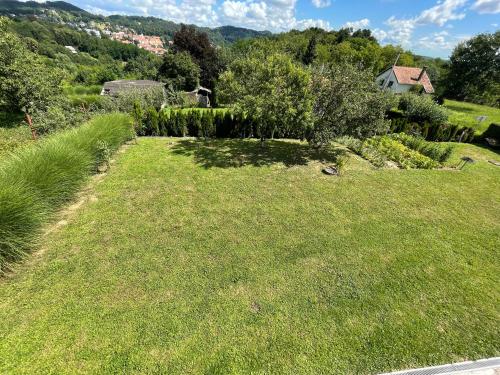 a large grassy hill with a house in the background at Rigel in Varaždinske Toplice