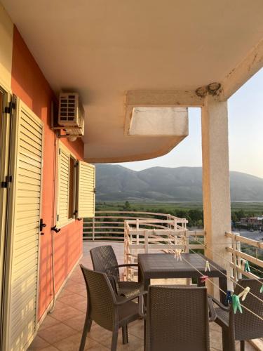 a patio with a table and chairs on a balcony at Horizon Apartments - Sea & Mountain View -Modern & Spacious Stay in Orikum
