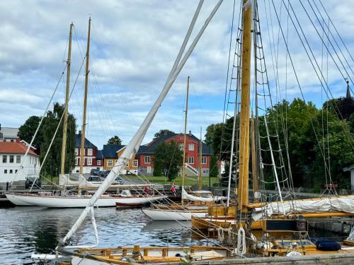 a group of sailboats are docked in a harbor at Tollgaarden Gjestegaard in Larvik