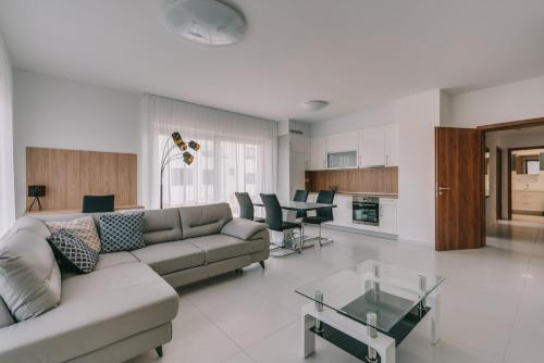 a living room with a couch and a table at BIRGÉS Villapark Apartments in Balatonfüred