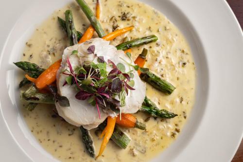 a bowl of soup with chicken and asparagus and carrots at Nevis Bank Inn in Fort William