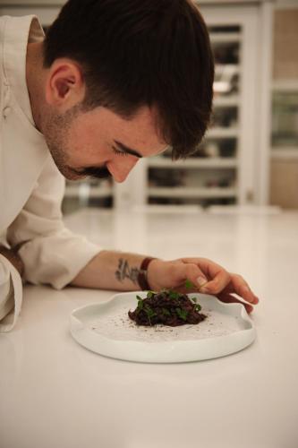 a man looking at a plate of food on a counter at RELAIS COLLE BUONO in Alvito