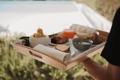 a person holding a tray with a plate of food at RELAIS COLLE BUONO in Alvito