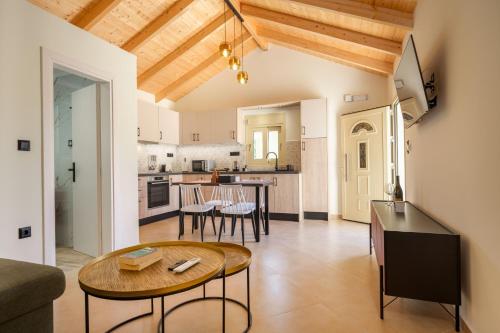 a living room with a table and a kitchen at Kosmas Villas in Skala Kefalonias