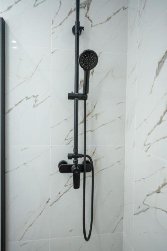 a shower in a bathroom with a shower head at Kosmas Villas in Skala Kefalonias