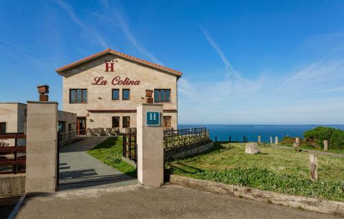 a building with a sign that reads la cuena at La Colina in Gijón