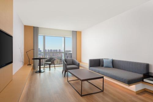 a living room with a couch and a table at Fairfield by Marriott Shenzhen Bao'an in Shenzhen