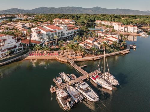 an aerial view of boats docked at a marina at Relais et Châteaux Thalasso & Spa Ile de la Lagune in Saint-Cyprien