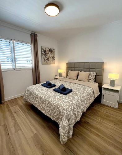a bedroom with a bed with two hats on it at Hero Apartment - Luxury in Maspalomas in Maspalomas