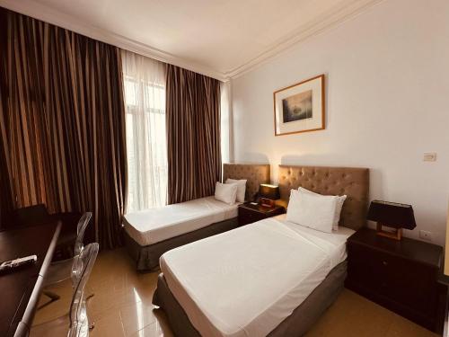 Postel nebo postele na pokoji v ubytování Sultani Hotel