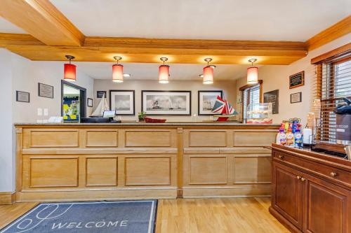 a kitchen with wooden cabinets and a counter top at Country Inn & Suites by Radisson, Annapolis, MD in Annapolis