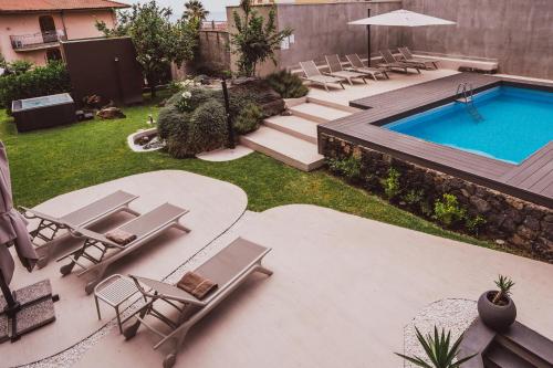 an overhead view of a backyard with a swimming pool and chairs at Ollen apartments in Catania