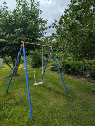 a swing set in the grass in a yard at Ferienwohnung Janke in Nossen