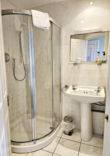 a bathroom with a shower and a sink at Dunns Houses Farmhouse B&B in Otterburn
