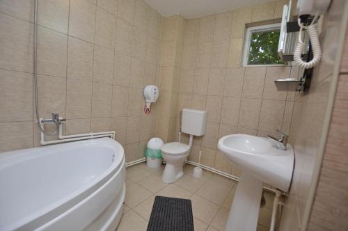 a small bathroom with a toilet and a sink at Casa Morena Tuzla in Tuzla