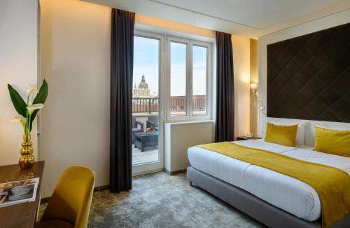 a hotel room with a bed and a large window at Leonardo Boutique Hotel Budapest M-Square in Budapest