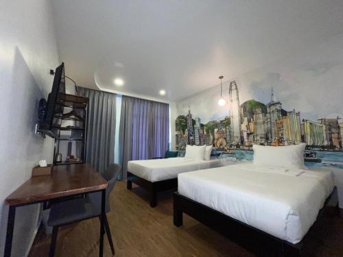 a hotel room with two beds and a desk at Times Hotel at Bassac Lane in Phnom Penh