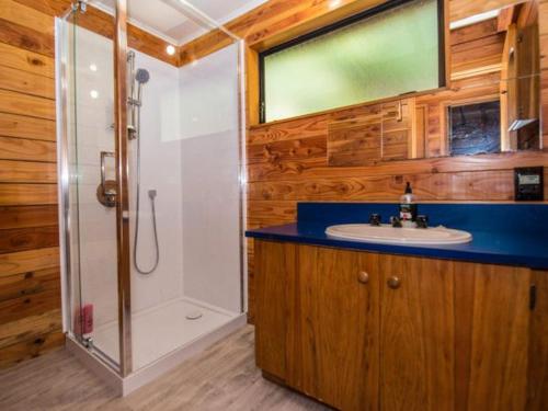 a bathroom with a shower and a sink and a toilet at Snow Chalet - Ohakune Chalet in Ohakune