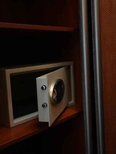 a microwave oven on a shelf in a room at Курортний Готель Золота Корона in Truskavets