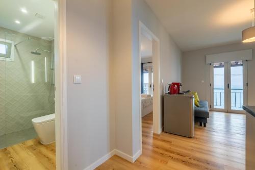 a bathroom with a shower and a toilet in a room at Casas das Hortas, Apartamento Vista Mar in Seixal