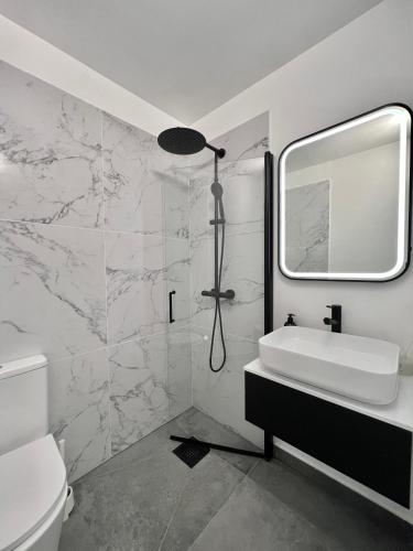 a bathroom with a sink and a mirror at Trolltunga Studios in Odda