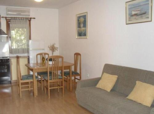 a living room with a couch and a table at Apartments White House in Supetar